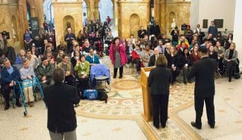 View from behind the podium towards the crowd of attendees at the state house.
