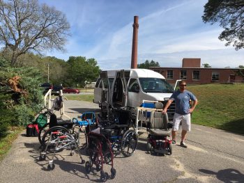 Van open with man and many items of D M E