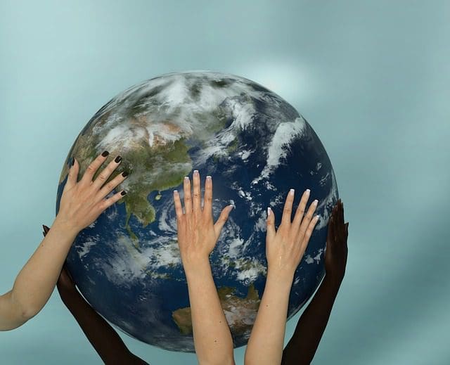 Hands on a globe of the earth