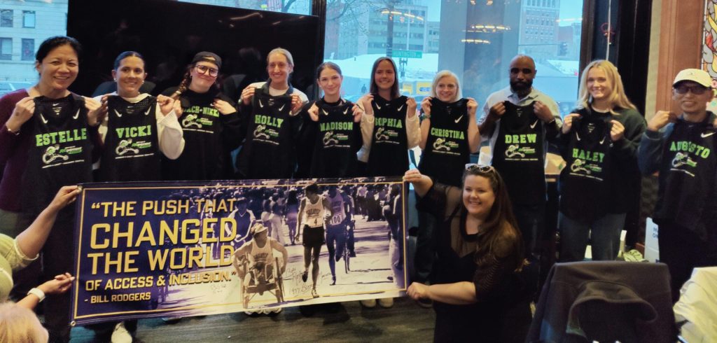 The team gathered for a picture holding behind a Bob Hall banner that reads: The Push that Changed the World.